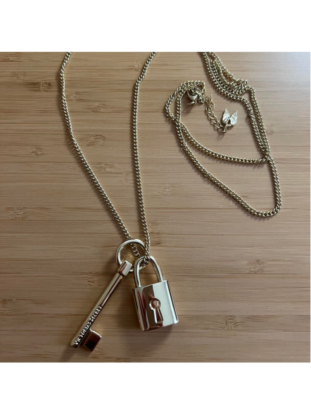 Victoria’s Secret long gold necklace with lock and key charms